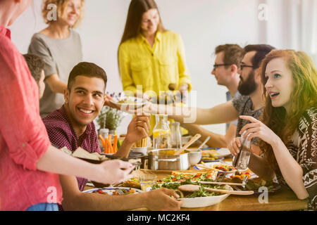 Group of vegan friends meeting and eating organic food in a restaurant Stock Photo