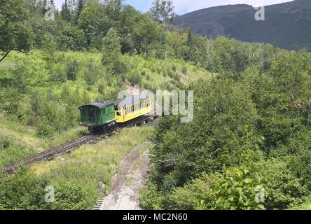 Rack and pinion locomotive pushing coach up the mountain on the Mt. Washington Cog Railway in New Hampshire Stock Photo