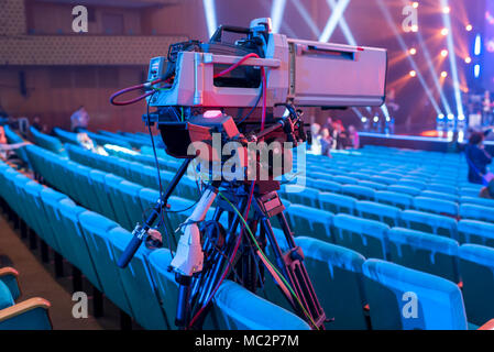 Professional video camera on a tripod with a screen for filming events and TV broadcasting from the concert hall Stock Photo