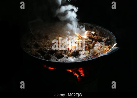 entrails chicken soup boil on large frying pan and smoke of food smell in vintage kitchen Stock Photo