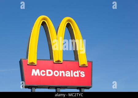 Stilling, Denmark - August 9, 2015: McDonald's logo on a pole. McDonald's is the world's largest chain of hamburger fast food restaurants Stock Photo