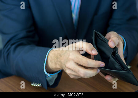 Men hands with suit showing an empty wallet Stock Photo