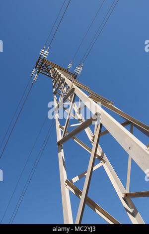 Electricity pylon against a blue sky Stock Photo