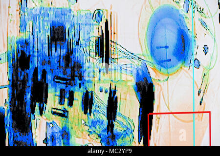 X-ray screenshot of an backpack filled with tele zoom camera and camcorder. Stock Photo