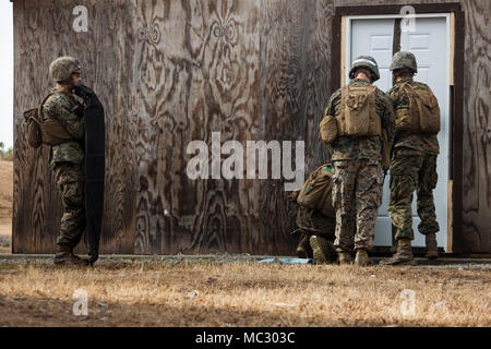 Marines in an Assaultman Course with the Infantry Training Battalion, School of Infantry East, prepare a detonation cord at ETA-8A engineer demolition training range and urban breaching facility on Marine Corps Base Camp Lejeune, N.C., Jan. 12, 2018. The exercise was held to demonstrate different demolition and explosive breaching training techniques, and to develop proficiency in mobility support for infantry units. (U.S. Marine Corps photo by Lance Cpl. Isaiah Gomez) Stock Photo