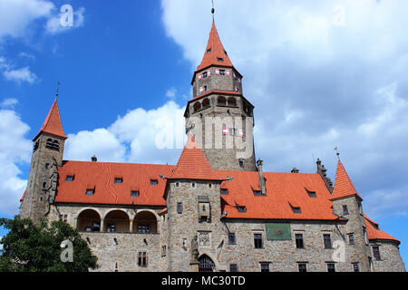 On the photo dominates the castle of Bouzov and in the backround you can see the blue sky with clouds. Stock Photo