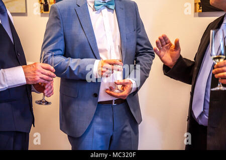 Men enjoying the party with a glass in the hand. Stock Photo