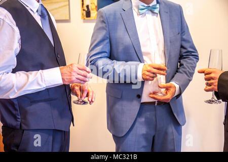 Men enjoying the party with a glass in the hand. Stock Photo