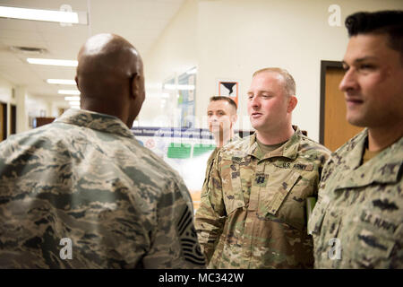 Army Capt. Christopher Gibbs, center, greets Chief Master Sgt. of the Air Force Kaleth O. Wright Jan. 25, 2018, at Sheppard Air Force Base's Inter-Service Training Organization as part of the CMSAF's two-day immersion visit to the base. While the ITRO is home to joint training for Air Force Airmen and Army Soldiers in specific career fields at Sheppard, the 82nd Training Wing also conducts joint training for the Navy and Marines. Also pictured include (front) Navy Lt. Leonardo Calderon and (back) Marine Gunnery Sgt. John McCrandall. (U.S. Air Force photo by Alan R. Quevy) Stock Photo