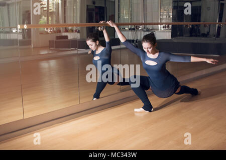 Beautiful ballerina practicing at the barre Stock Photo