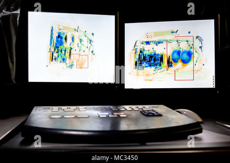 X-ray system scanning of an backpack filled with tele zoom camera and camcorder. Stock Photo