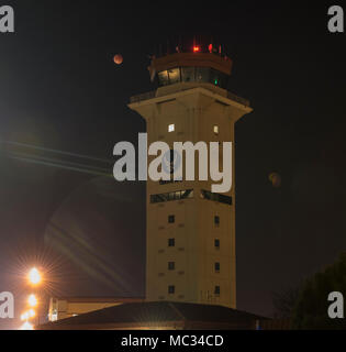 Super blue blood moon is a compound lunar phenomenon involving perigee brightness, calendar rarity, and eclipse totality. The archival photographic record preserves the 31 January 2018 moonset observed from Travis Air Force Base in California. Stock Photo