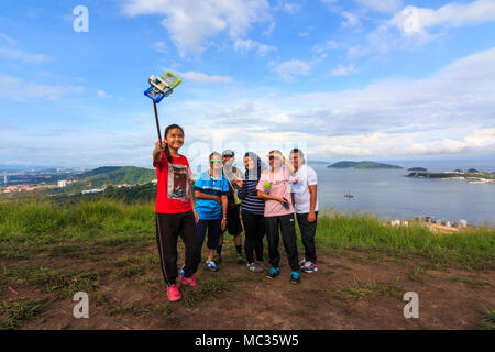 Sabah, Malaysia - August 06, 2016 : A group of  hikers taking selfie on top of the mountain . Image has grain or subject is blurry or noise or out of Stock Photo