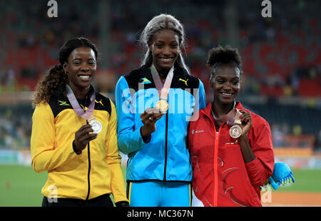 Bahamas' Shaunae Miller-Uibo (centre), Jamaica's Shericka Jackson (left) and England's Dina Asher-Smith (right) celebrate with their gold, silver and bronze medals in the Women's 200m at the Carrara Stadium during day eight of the 2018 Commonwealth Games in the Gold Coast, Australia. Stock Photo