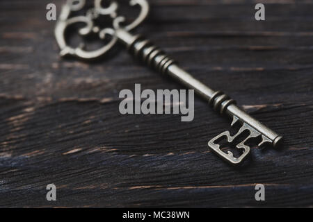 Vintage skeleton key on a table. Close-up Stock Photo