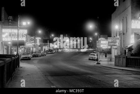 Nighttime scene of the streets of a small town in Alabama, ca. 1958. Stock Photo