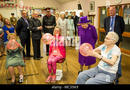 Queen Elizabeth II watches elderly keep fit enthusiasts being put