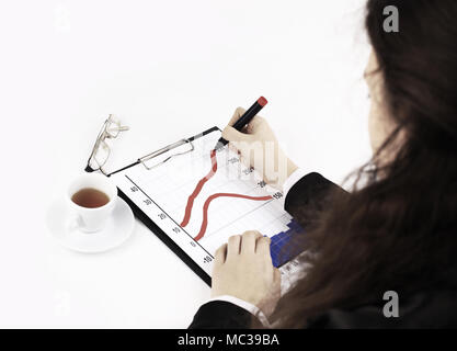 Closeup of business lady s hand with pen signing a contract on the background of her other hand touching the table Stock Photo