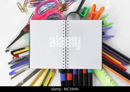 opened Notepad on office supplies on white background Stock Photo