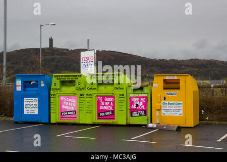 Colourful steel clothing banks for charities located in the local Tesco Extra car park at Newtownards County Down Northern Ireland Stock Photo