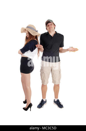 An upset young couple standing isolated for white background turning there back and are helpless about the situation Stock Photo