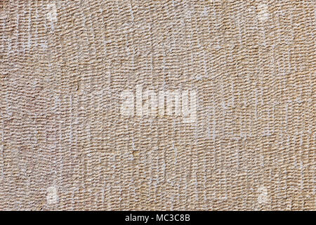 Clay plaster on wall of fence with texture of pattern similar to sackcloth. Stock Photo