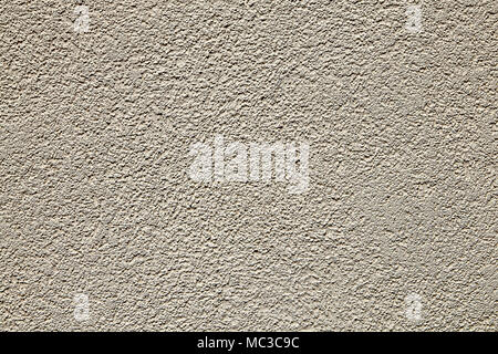 Vertical surface of the wall with beige textured plaster. Stock Photo