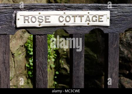 Rose Cottage House Name Plaque on an Old Rustic Wooden Gate. Bickleigh, Tiverton, Devon, UK. April, 2018. Stock Photo