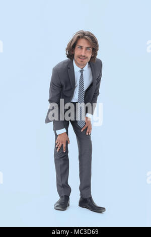 young businessman stooping down and walking full length photo over white background Stock Photo