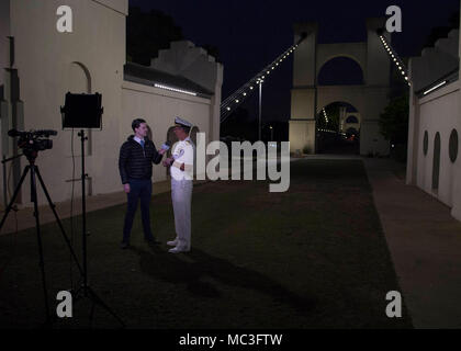 Texas (April 2, 2018) Rear Adm. Jay Bynum, Chief of Naval Air Training and Waco native, fields questions from Jamie Kennedy, local KCEN TV news reporter, at the Waco Suspension Bridge as Waco Navy Week gets underway. The Navy Office of Community Outreach uses the Navy Week program to bring Navy Sailors, equipment and displays to approximately 15 American cities each year for a week-long schedule of outreach engagements. Stock Photo