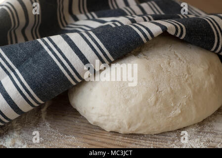 yeast dought on wooden table covered with cloth Stock Photo