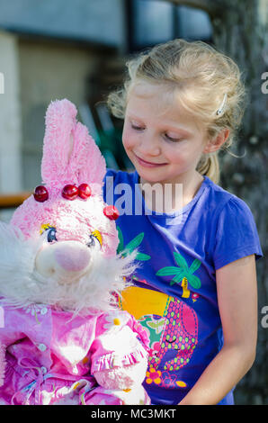 adorable blond girl  with toy Stock Photo