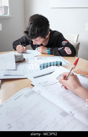 Children revising exams paper together Stock Photo