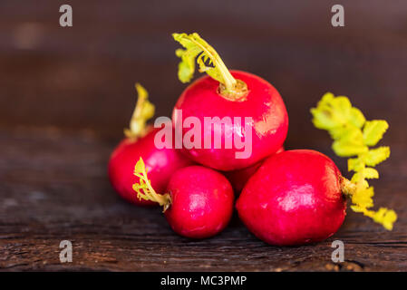 Fresh red radishes on wooden surface close Stock Photo