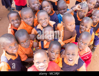 Kayanja, Uganda. June 13 2017. A group of happy primary-school children smiling, laughing and waving at the Primary school in Kayanja. Stock Photo