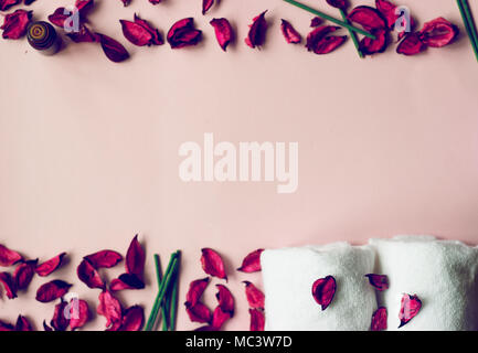 Towels, potpourri and scented sticks on pink background with copy space for your text; wellness or spa background Stock Photo