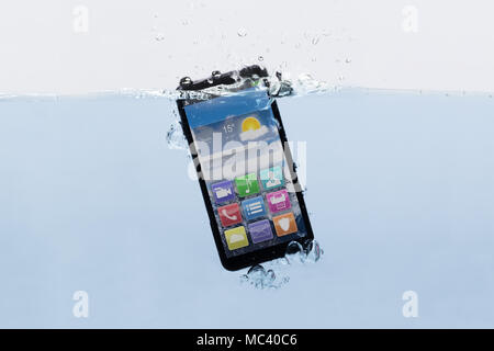 Close-up Of A New Black Mobile Phone Submerged In Water Stock Photo