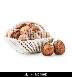Walnuts in porcelain basket, whole walnut heap as healthy eating and dieting concept, group of objects isolated on white background with clipping path Stock Photo