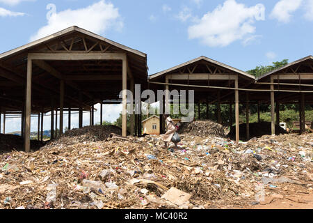 Jinja, Uganda. 21 May 2017. A little girl scavenging food or anything useful in a landfill in Uganda, Africa. Stock Photo