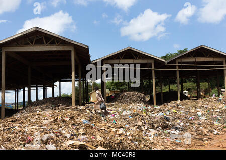 Jinja, Uganda. 21 May 2017. A little girl scavenging food or anything useful in a landfill in Uganda, Africa. Stock Photo