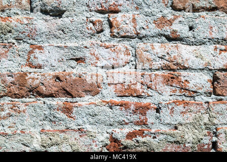 Red bricks and mortar wall texture on old house on daylight, close up Stock Photo