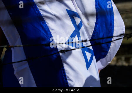A Israel flag and barbed wire is seen at the former Nazi German Auschwitz-Birkenau death camp during the 'March of the Living' at Oswiecim. The annual march honours Holocaust victims at the former Nazi German Auschwitz-Birkenau death camp in southern Poland. Stock Photo