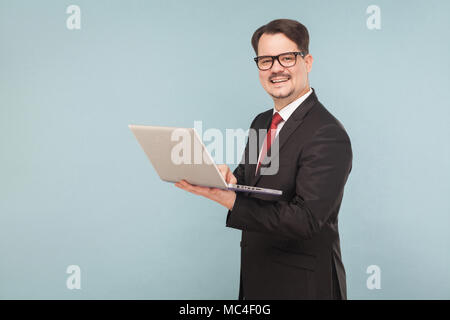 Business, gadgets,technologies. Man working in lap top. Indoor, studio shot, isolated on light blue or gray background Stock Photo