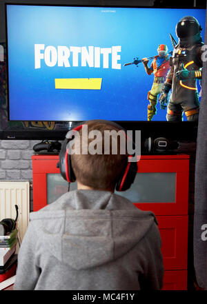 A boy plays Fortnite Battle Royale on his Xbox one Stock Photo