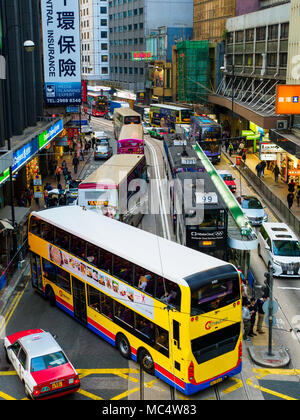 Hong Kong Traffic congestion - Buses Trams and Taxis mix in Central Hong Kong. Stock Photo