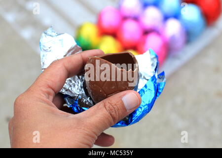 Close up of half eaten Easter egg chocolate isolated Stock Photo