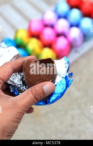 Close up of half eaten Easter egg chocolate isolated Stock Photo