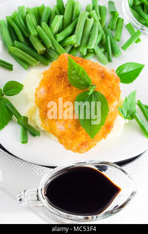 Top view of fried chicken, mashed potatoes and green beans with leek Stock Photo