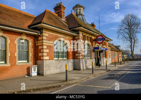 Barkingside, Ilford, Essex, UK - April 6, 2018: Exterior view of Barkingside Underground station with a passenger leaving from the entrance. Stock Photo