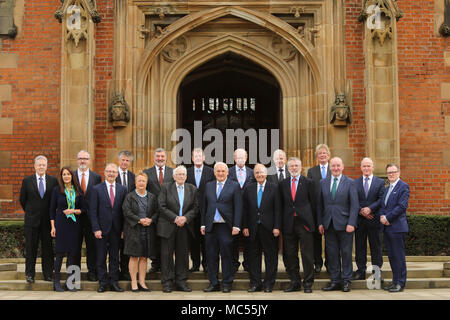 Posing for a class photo outside Queen's University Belfast, Tuesday, April 10th, 2018.  Isabel Jennings (Queen’s University Belfast), Professor James McElnay (Queen’s University Belfast), Monica McWilliams, Seamus Mallon, former Taoiseach Mr Bertie Ahern, Senator George J. Mitchell, Gerry Adams, Mark Durkan and Professor Ian Greer (incoming Vice Chancellor of Queen’s University Belfast.)  Back row from left:  Peter Robinson, Professor Richard English (Queen’s University Belfast), Jonathan Powell, Lord John Alderdice, Lord David Trimble, Sir Reg Empey, Paul Murphy, Professor Hastings Donnan (Q Stock Photo